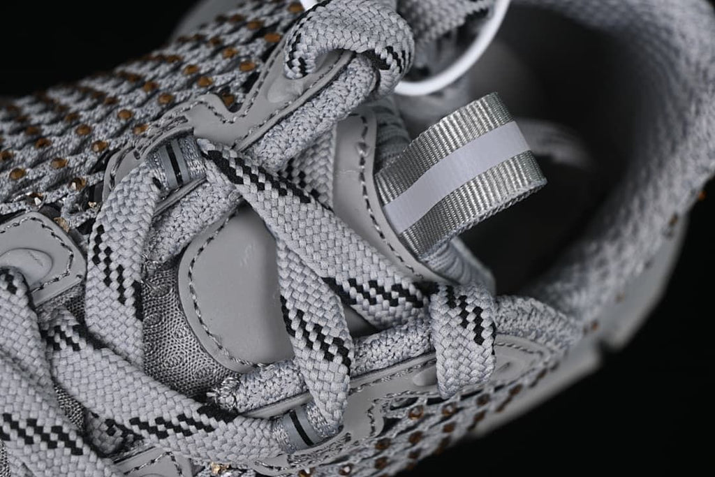 Close-up of the lace-up area, tongue, and heel pull tab.