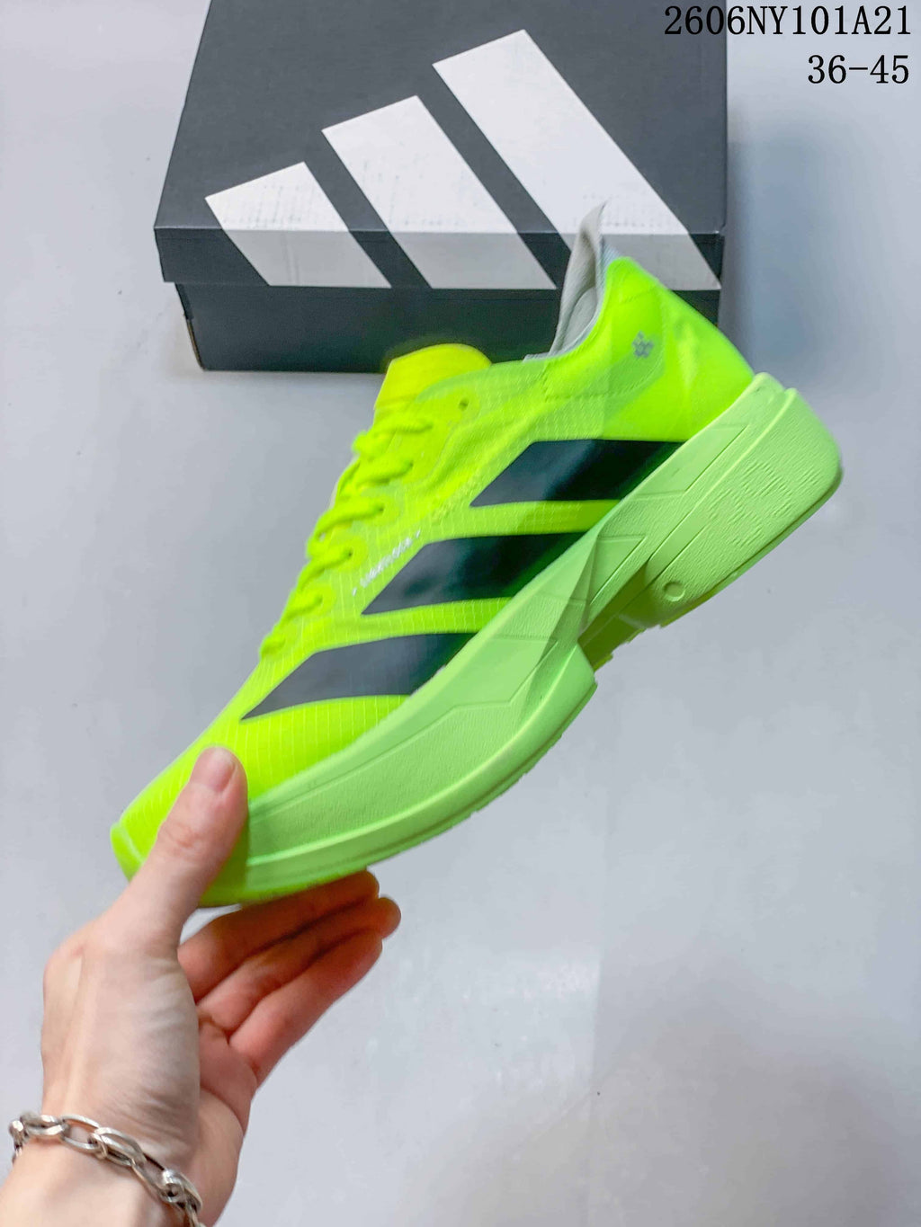 Side view of the neon yellow shoe with dark stripes and a sculpted sole.