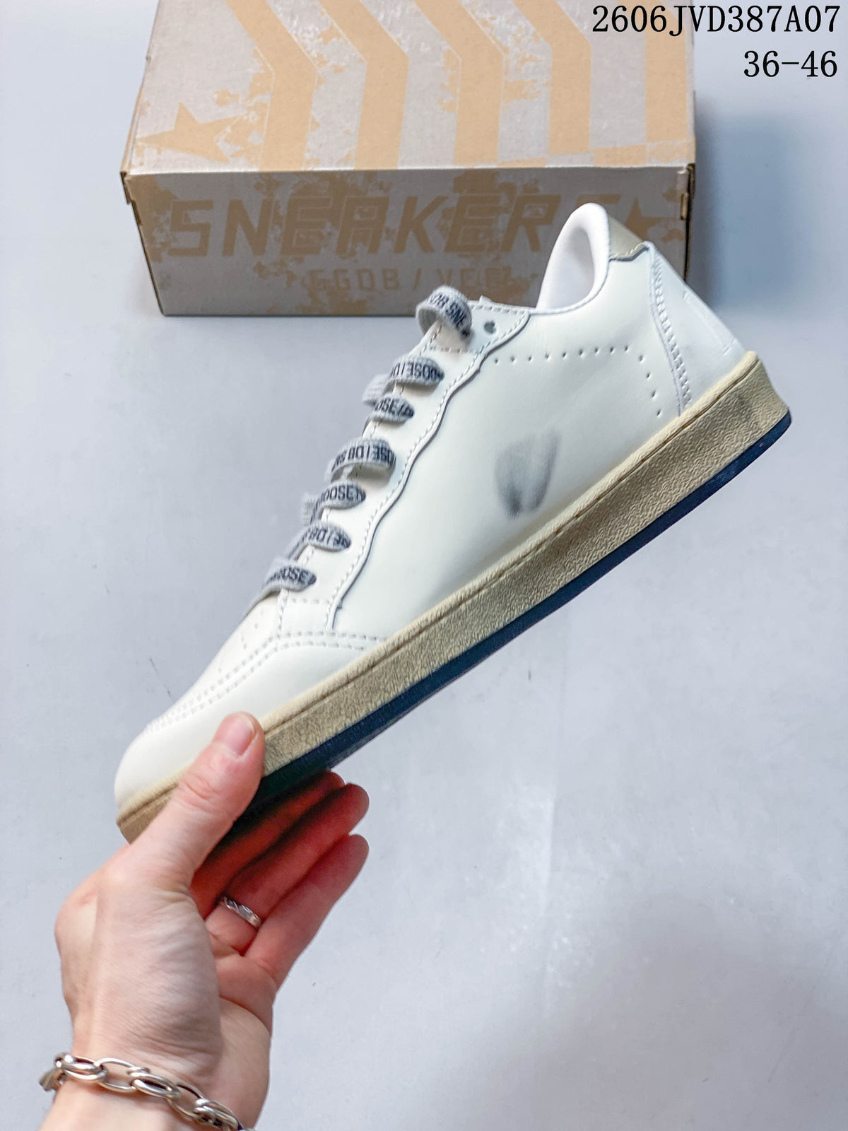 Side view of the white low-top sneaker with perforations and a distressed-look midsole
