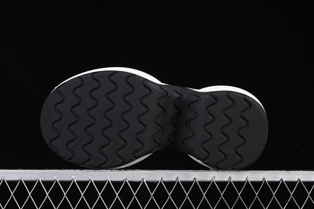 Underside view showing the black wavy tread pattern
