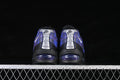 Rear view of black and purple Nike Air Max 95 sneakers with silver heel panels and visible cushioning windows