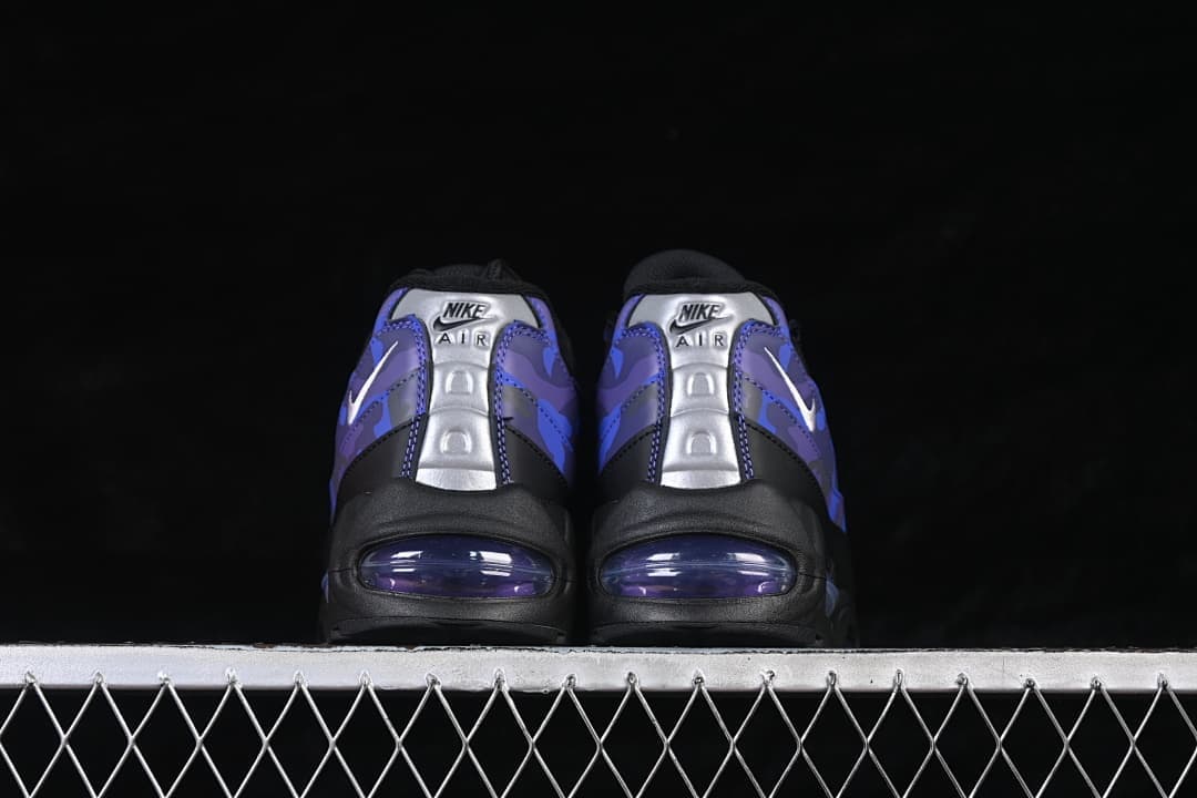 Rear view of black and purple Nike Air Max 95 sneakers with silver heel panels and visible cushioning windows