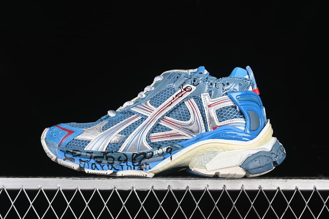 Side view of a blue, silver and red Balenciaga Runner sneaker