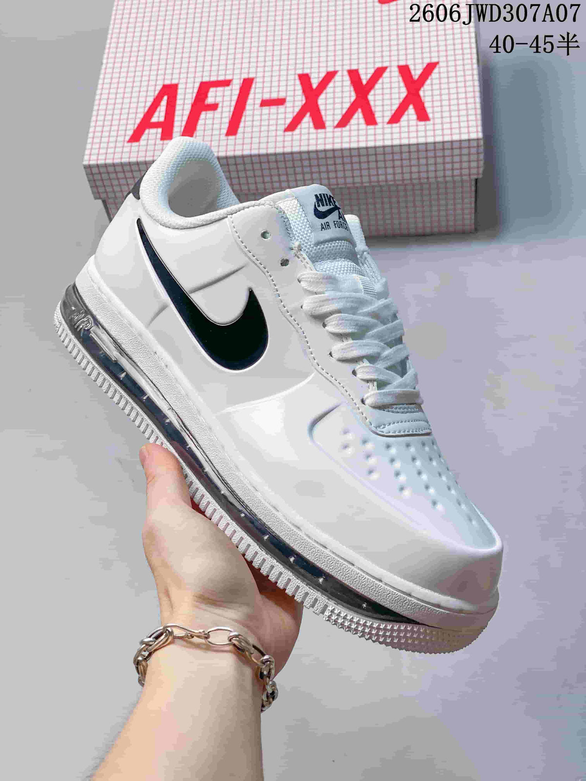Angled side view of the white sneaker with a dark Swoosh and visible air unit.