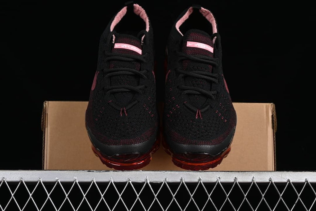 Front view of the pair showing black knit uppers and translucent red soles