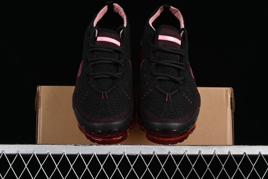 Front view of the pair showing black knit uppers and translucent red soles