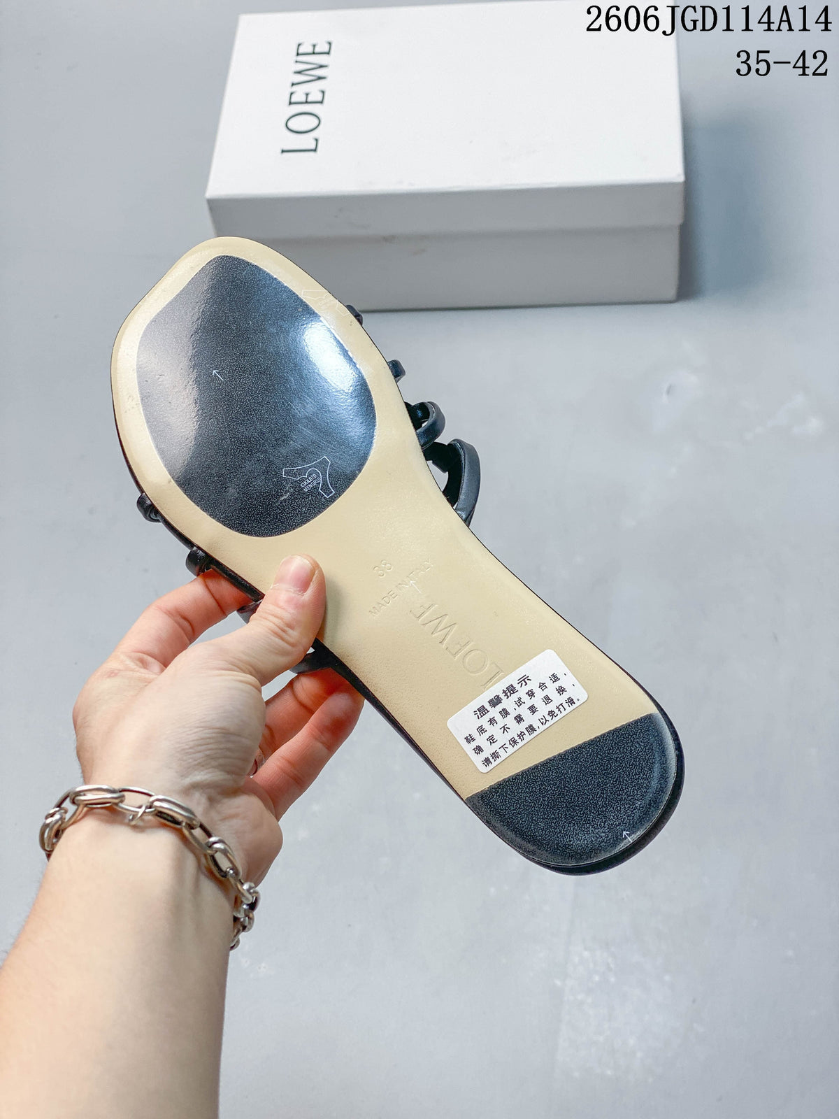Underside of a dark navy slide sandal showing a light-colored sole section and embossed markings.