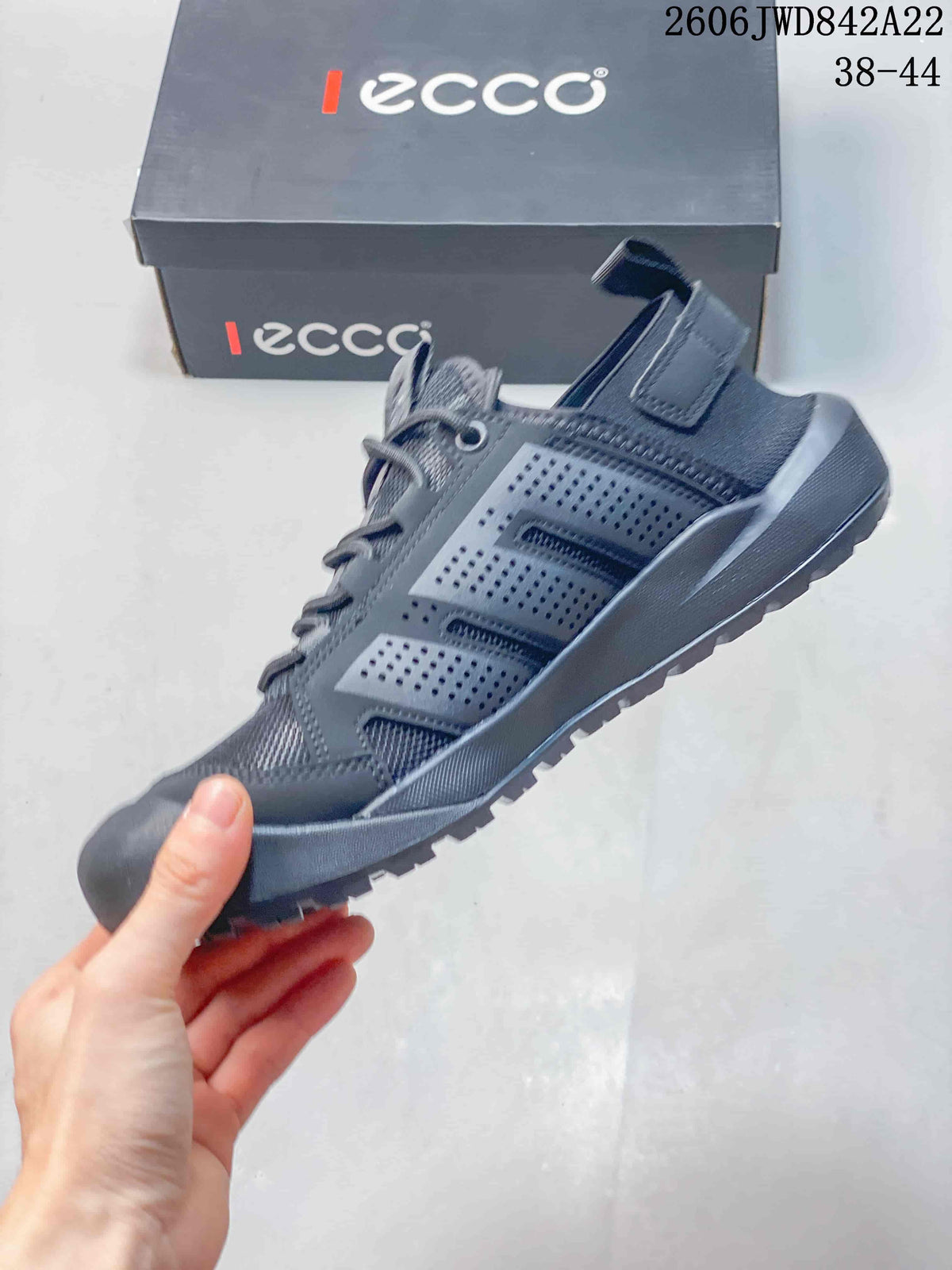 Side view of a gray lace-up sneaker with perforated panels