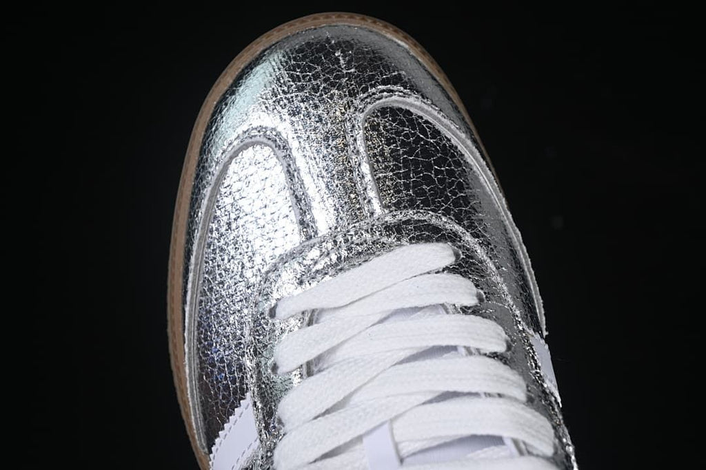 Top-down detail of the textured silver toe and white laces