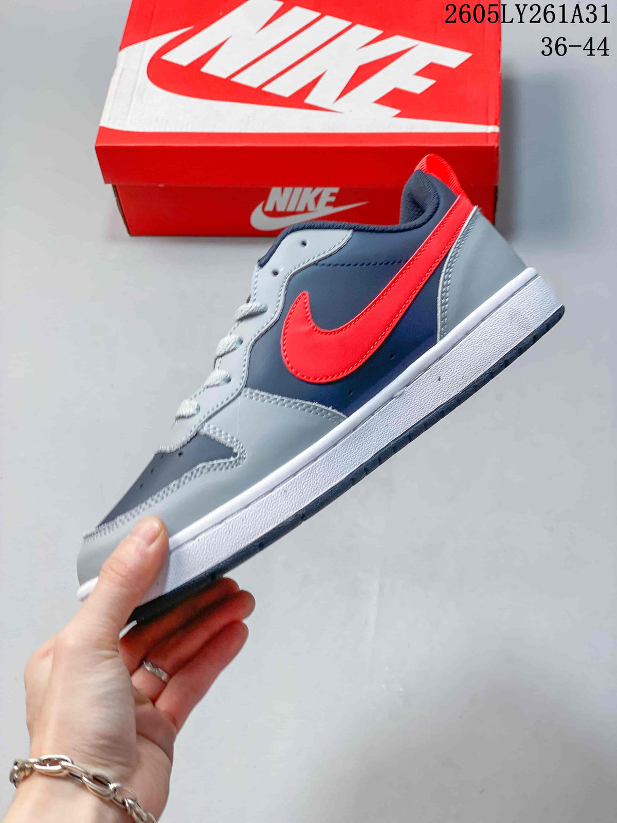 Side view of the low-top sneaker with a bright red Swoosh and navy and gray panels