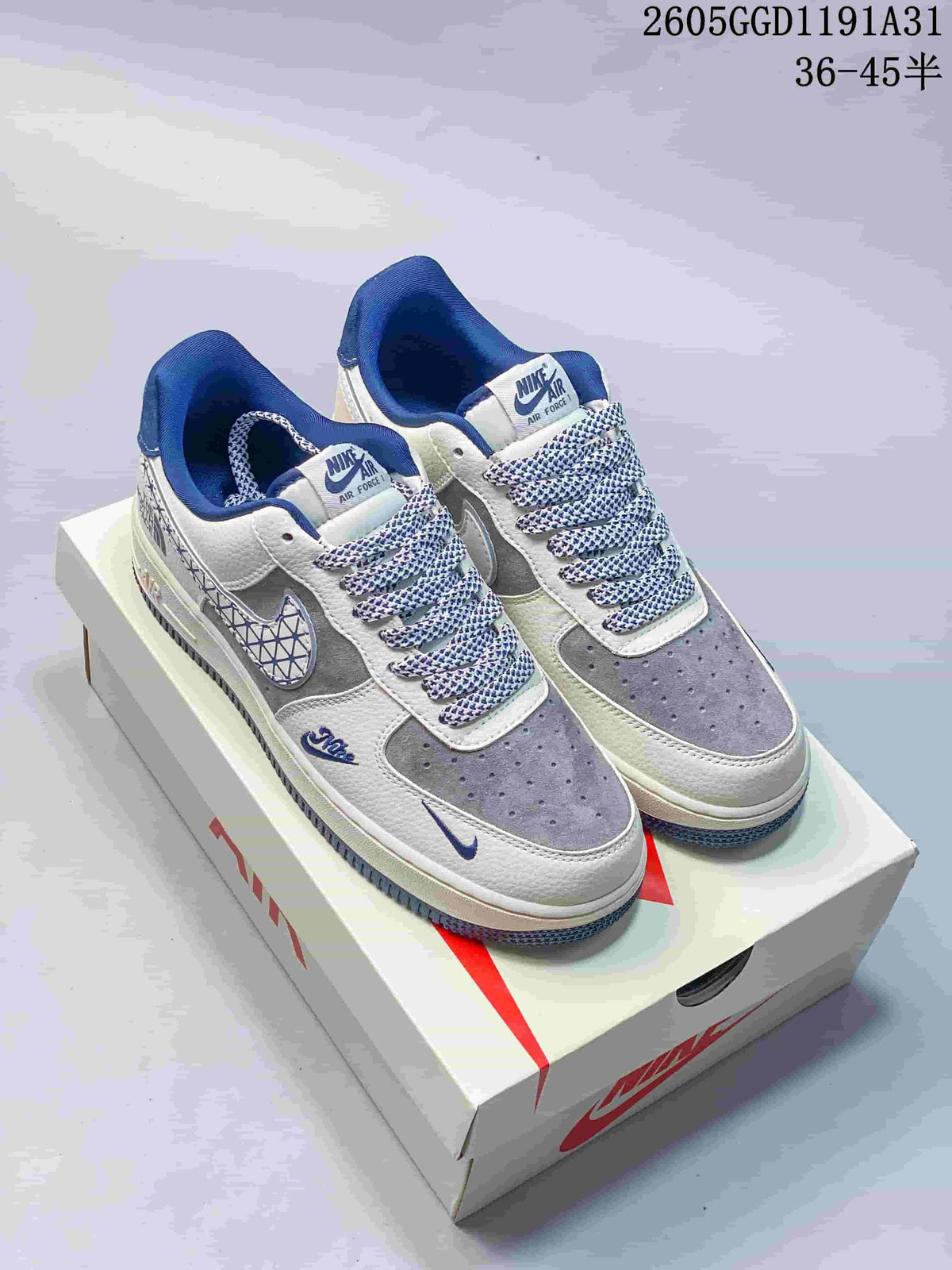 Pair of grey, off-white and blue low-top Air Force 1 sneakers with patterned laces, displayed on a shoe box.