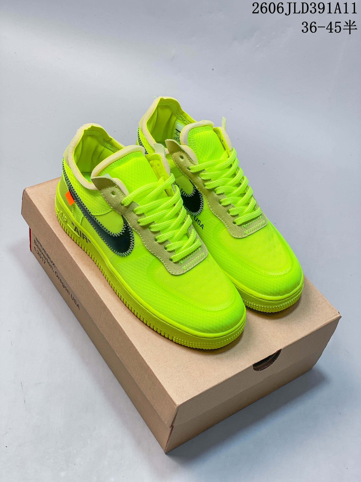 Pair of bright volt-green low-top sneakers on a brown shoebox