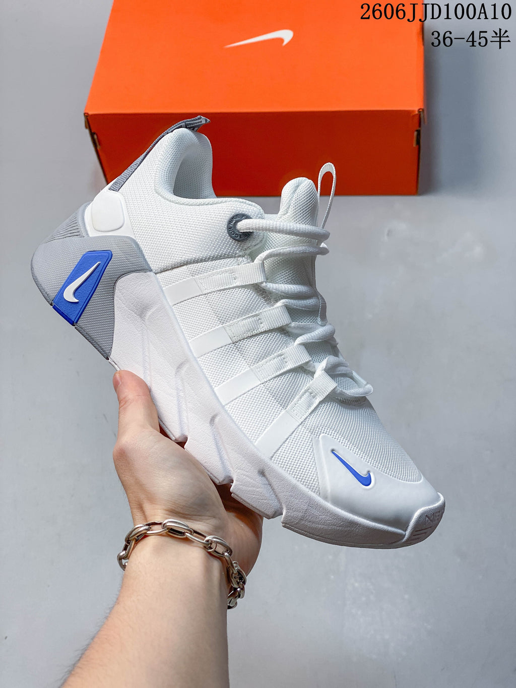 White and grey Nike Free Metcon 7 shoe with blue accents.