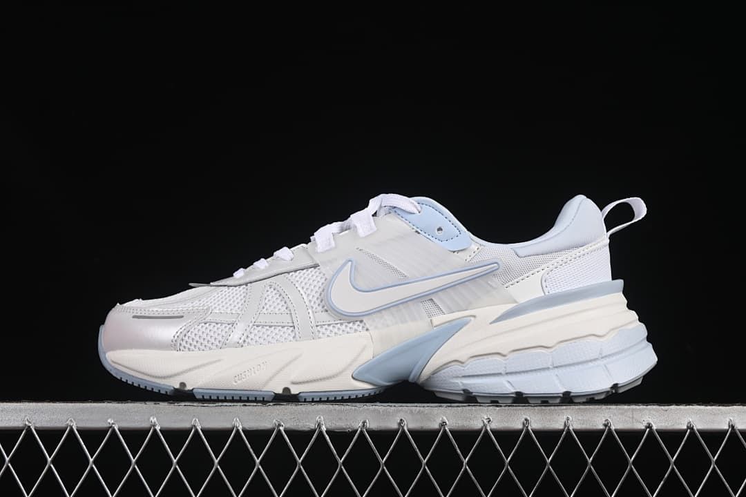 Side view of white Nike V2K Run sneakers with pale blue accents