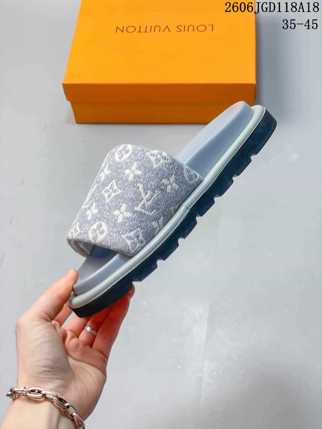 Side view of the gray patterned slide sandal with ridged outsole