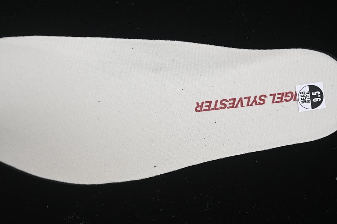 Light-colored insole with Nigel Sylvester branding and a sample size sticker