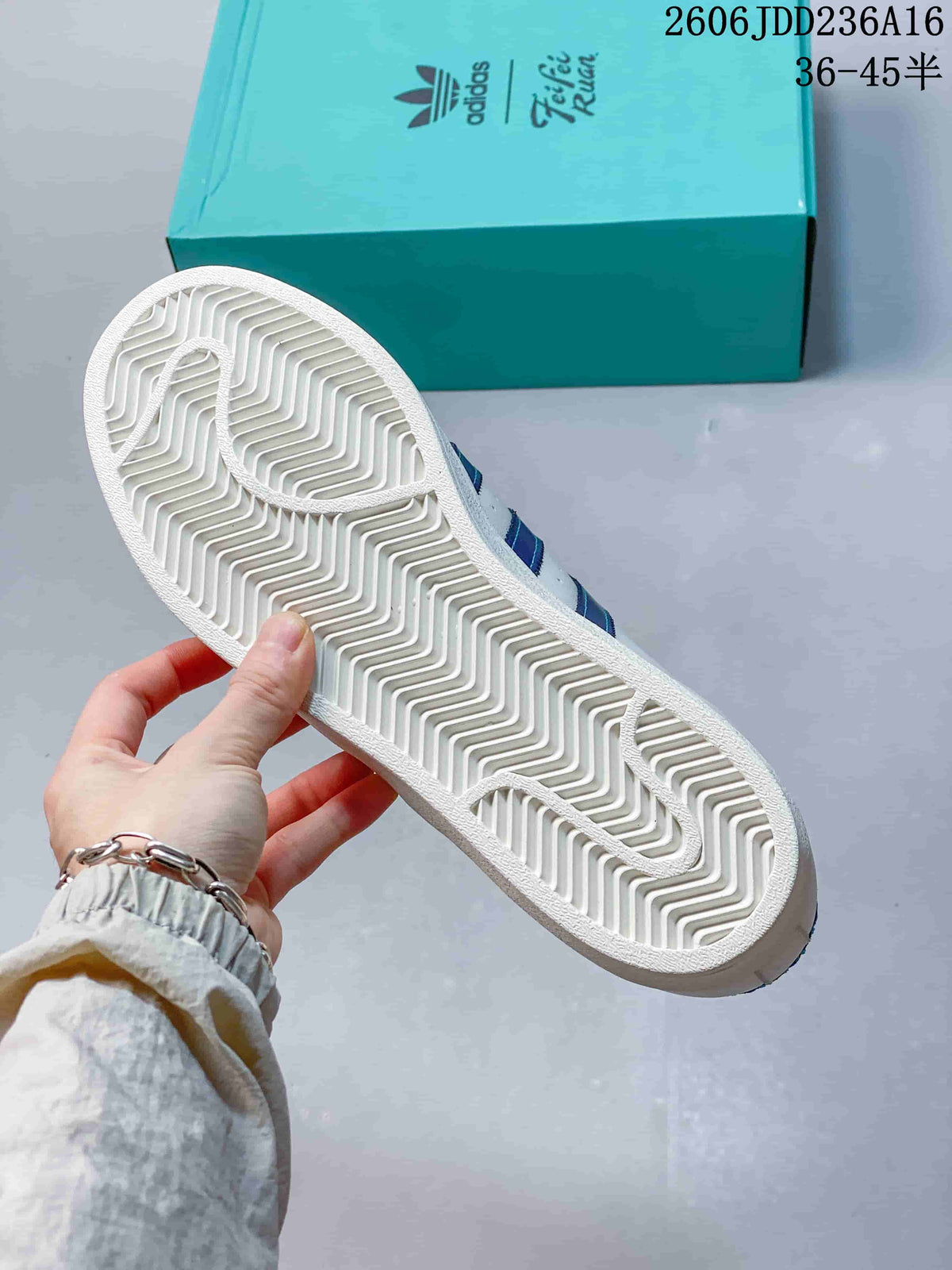 View of the white patterned outsole on an Adidas Superstar sneaker.