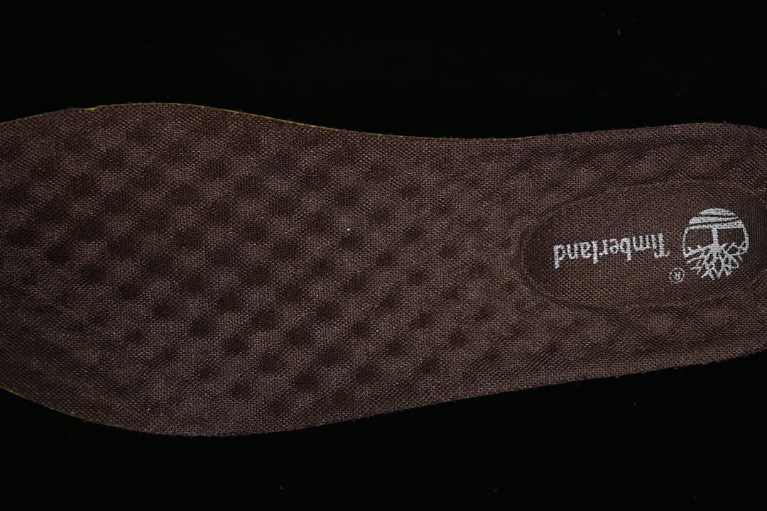 Close-up of the dark patterned insole with Timberland branding