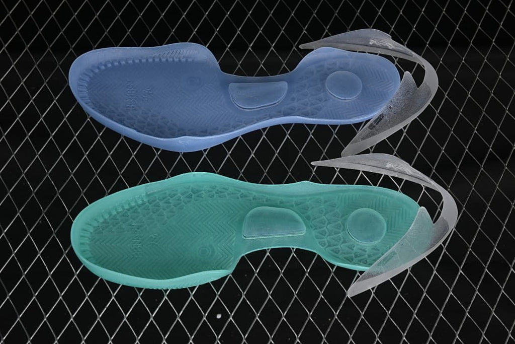 Two translucent shoe outsoles shown from below