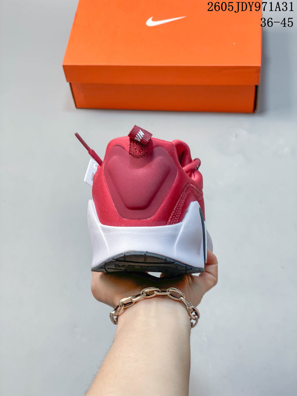 Rear view of the red Nike Free Metcon 6 shoe with a white heel section