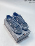 Dark blue Converse One Star Pro sneakers shown from above on a shoebox.