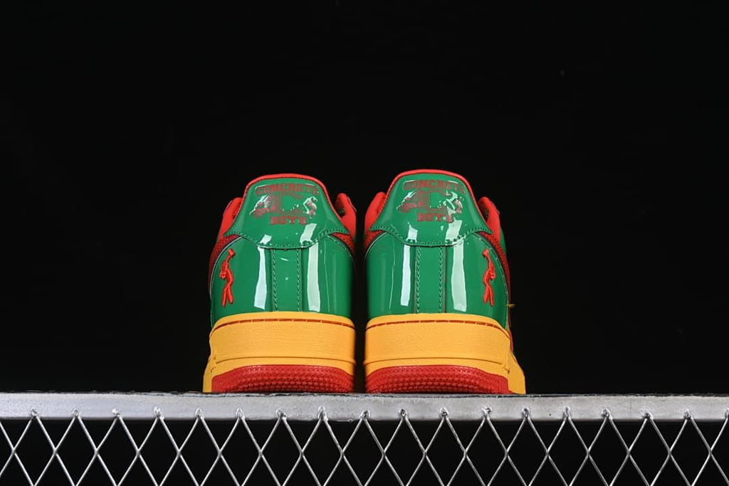Rear view of both shoes with green heel panels and decorative details