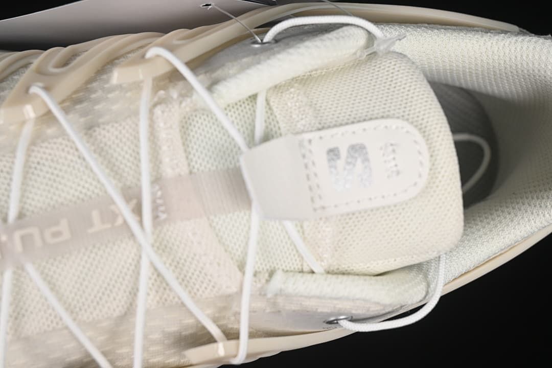 Top-down close-up of the tongue, laces and textile upper.