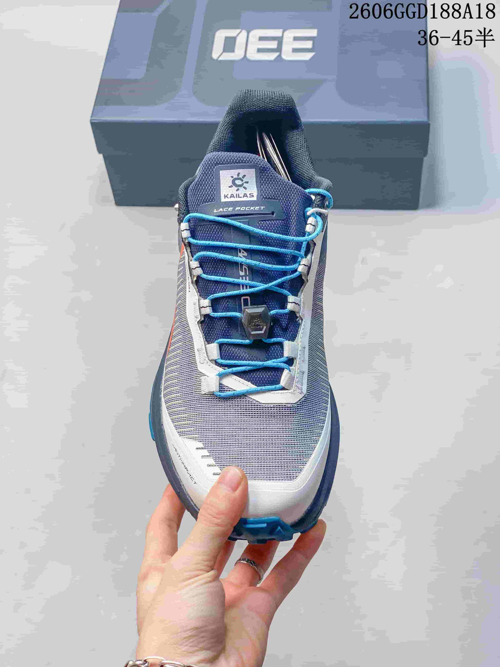 Top view of the shoe tongue, lace pocket, and blue quick-lacing system