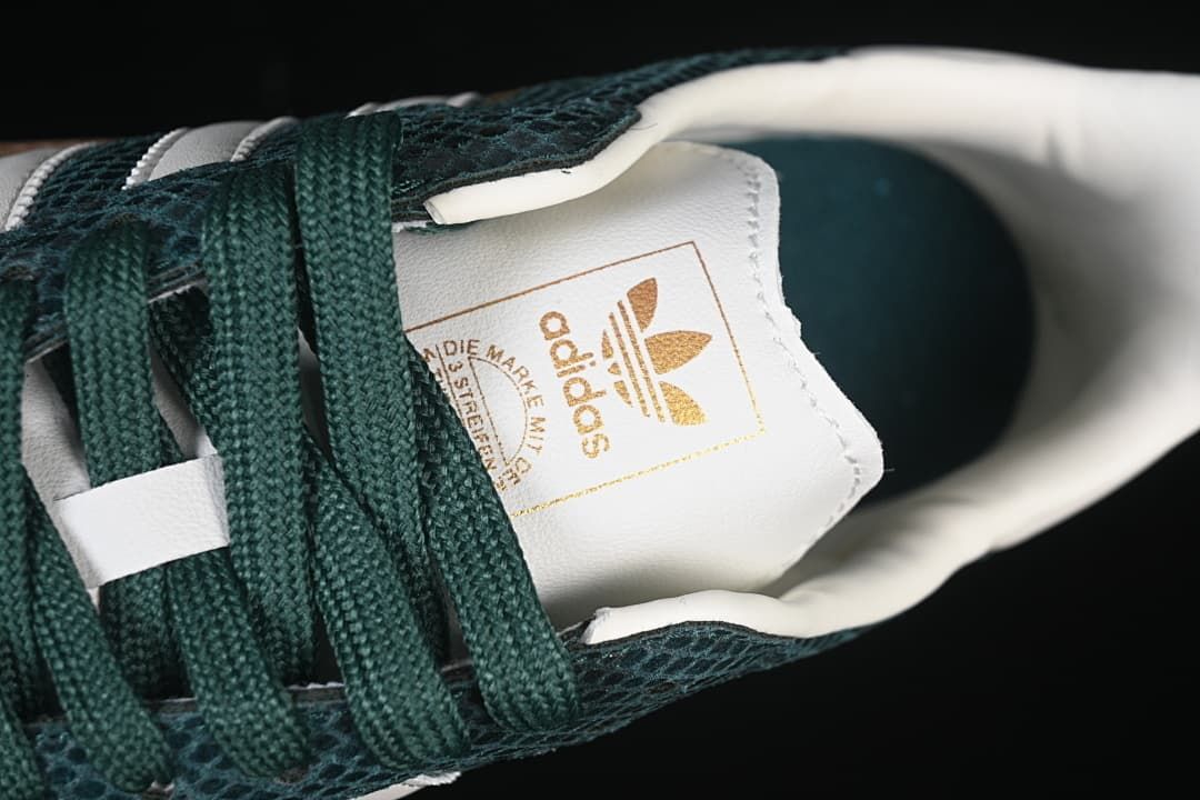 Close-up of the white tongue label and green laces
