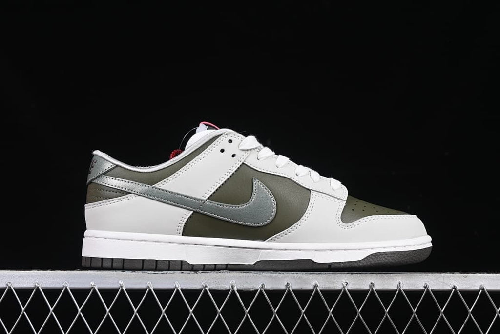 Side profile of the low-top sneaker with white, olive, and metallic silver panels.