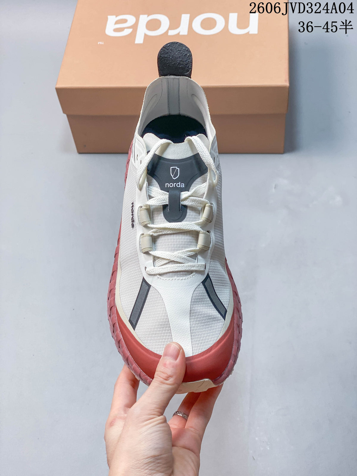 Top view of a white Norda sneaker showing its laces and dark tongue detail.