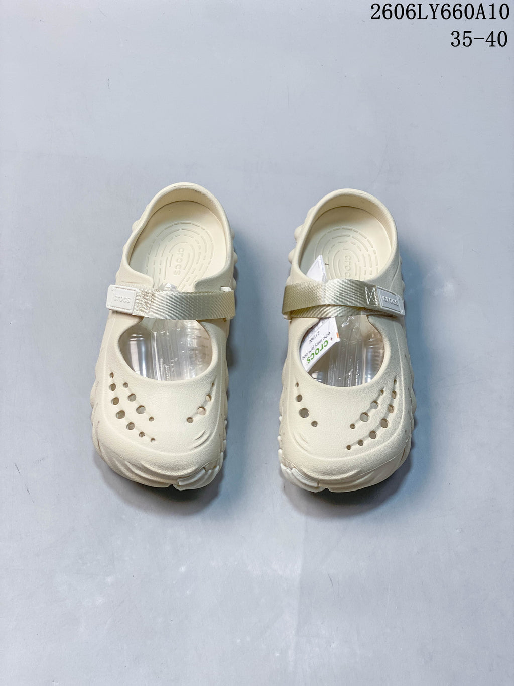Pair of cream Crocs Mary Jane-style clogs viewed from above, with perforated toes and instep straps.