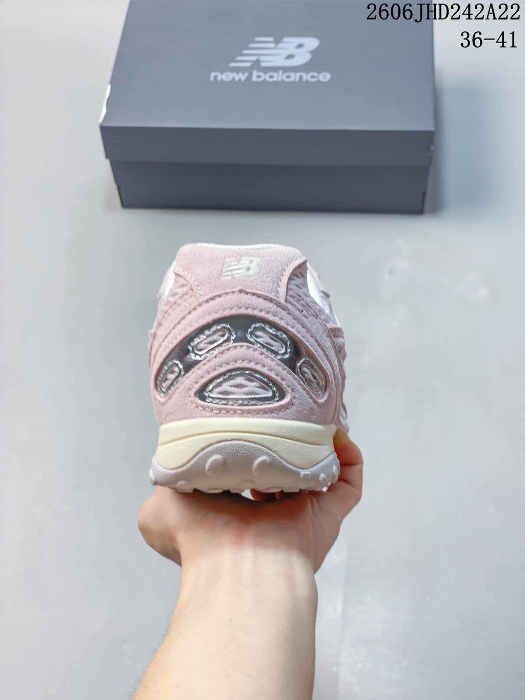 Rear view of a pink sneaker showing its heel details and sole.