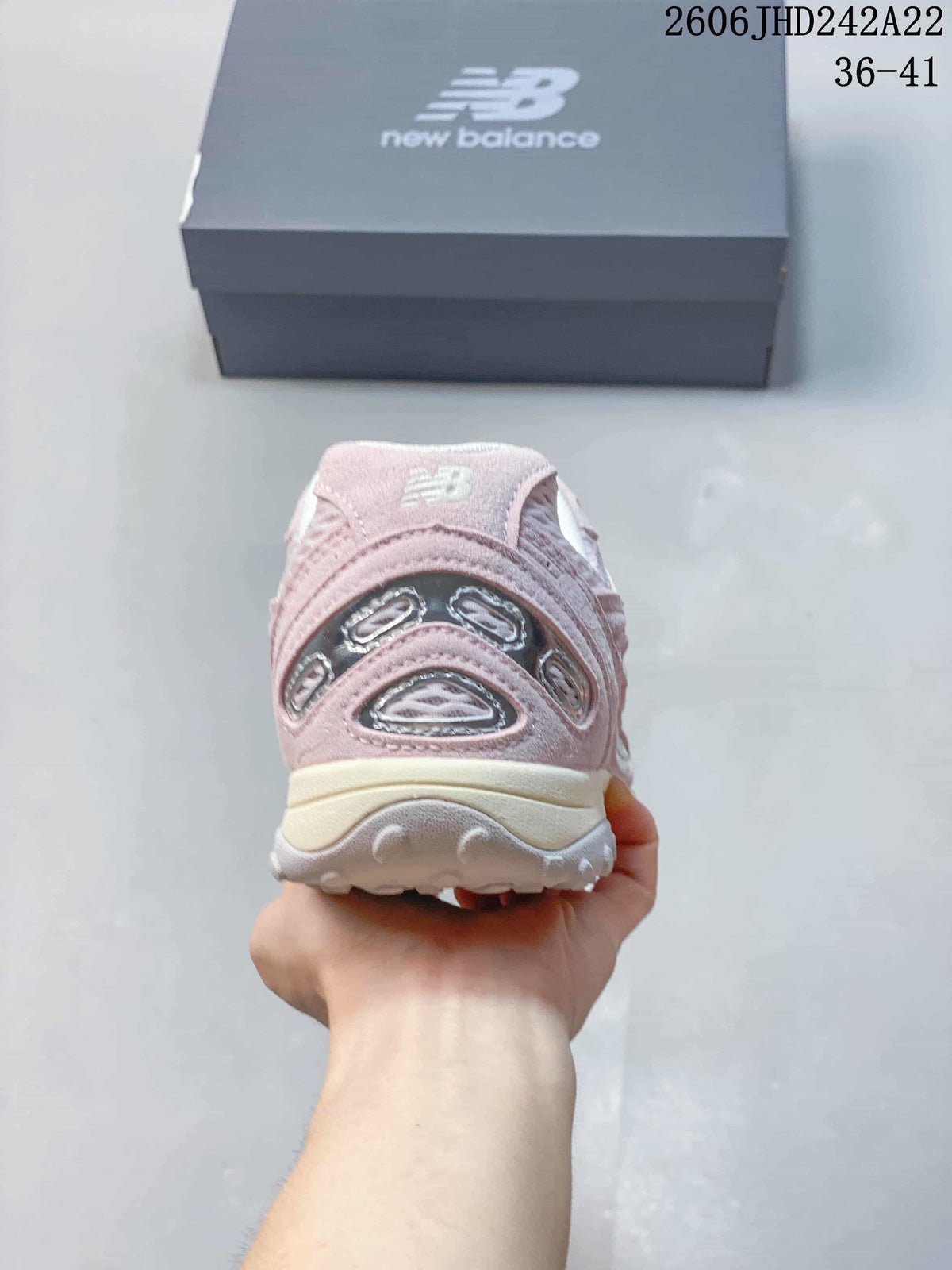 Rear view of a pink sneaker showing its heel details and sole.