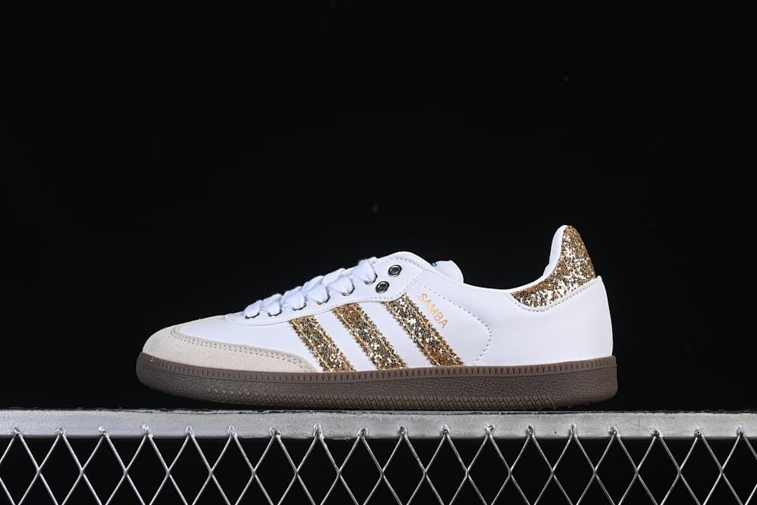 Side view of a white adidas Samba OG with gold glitter-style stripes and heel accent