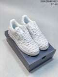 White Nike Air Force 1-style low-top sneakers with raised star and geometric detailing
