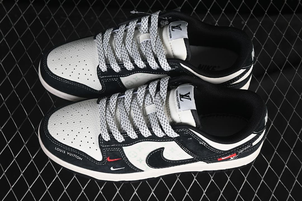 Top view of a pair of black and white low-top sneakers with patterned laces
