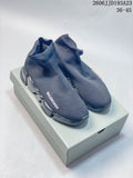 Pair of gray Balenciaga sock-style sneakers with segmented transparent soles