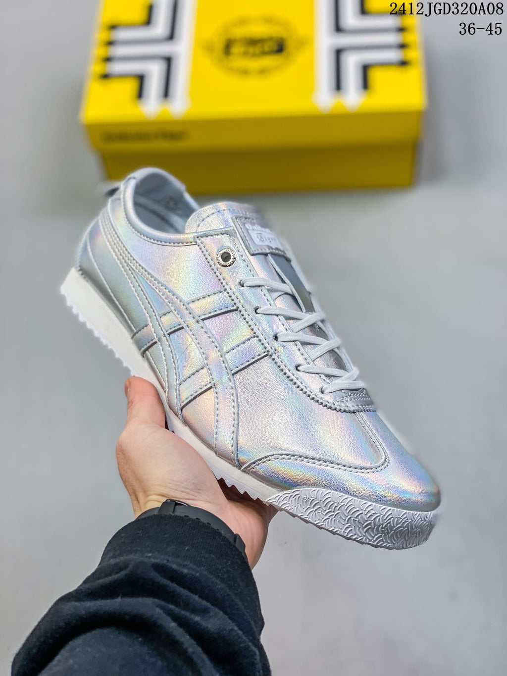 Angled view of an iridescent silver low-top sneaker with side stripes and white outsole