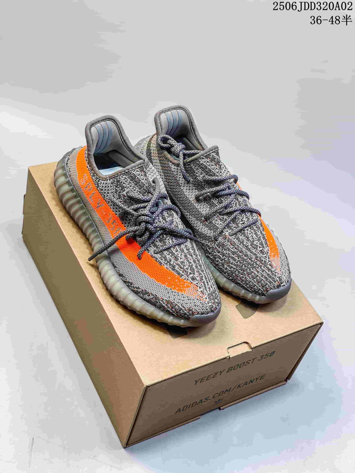 Pair of gray Adidas Yeezy Boost 350 V2 sneakers with orange side stripes on a shoe box; image overlay states 36–48.5.