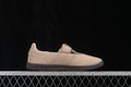Side profile of a light beige adidas Samba Jane sneaker showing the strap upper, perforated side detailing and dark rubber outsole.
