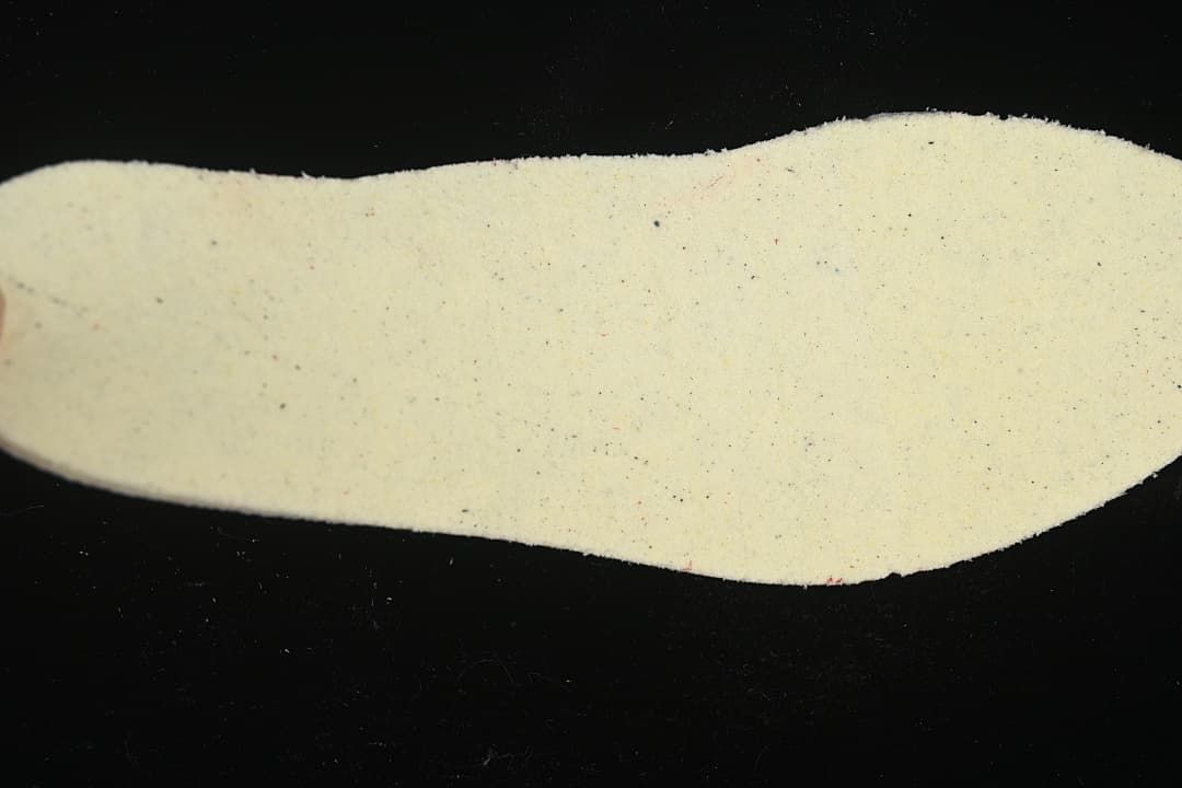 Light-colored shoe insole shown separately