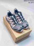 Pair of gray and pale pink Salomon XA Pro 3D shoes on a shoebox
