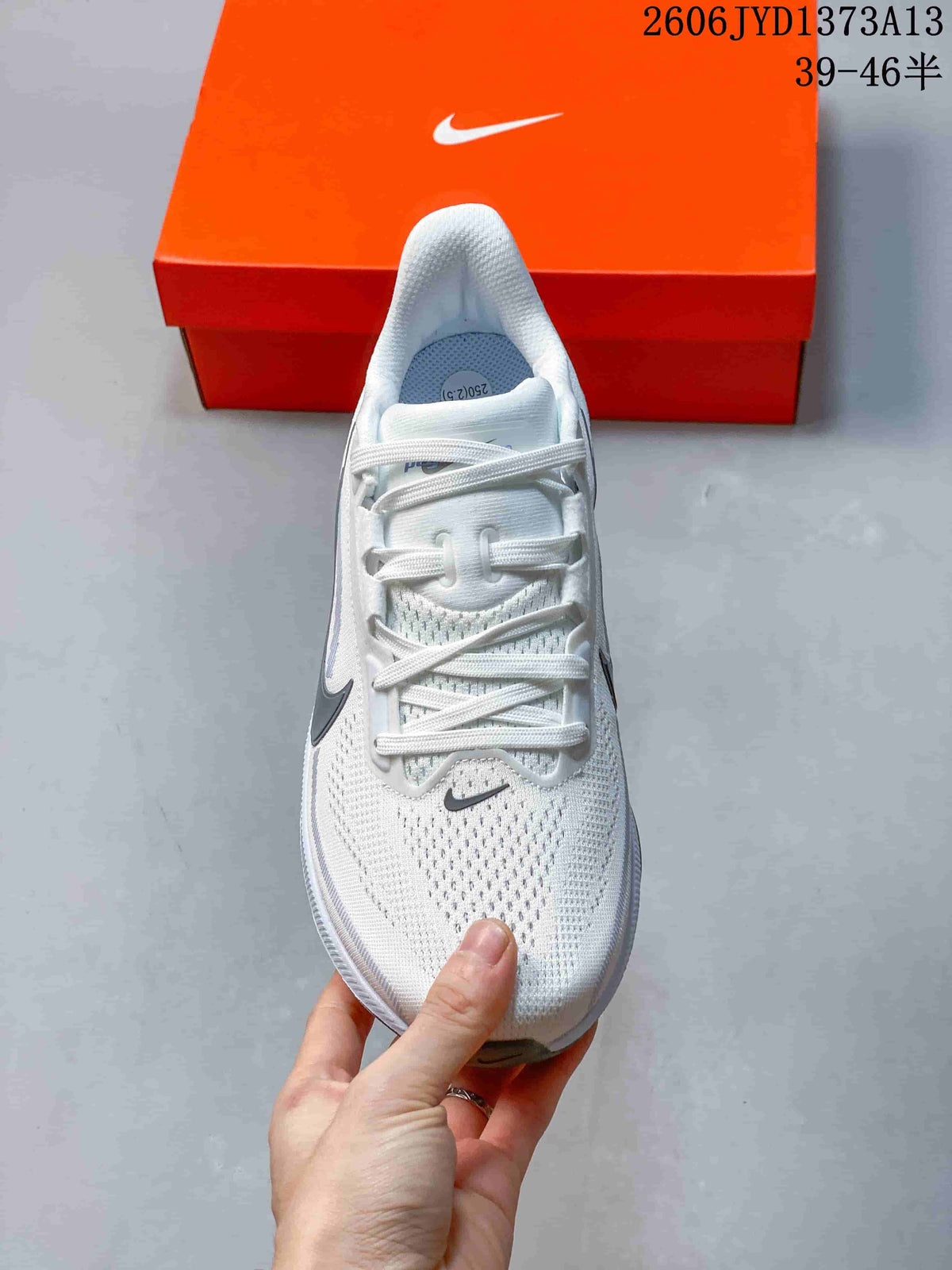 Top view of a white Nike Pegasus 42 running shoe with laces and perforated upper