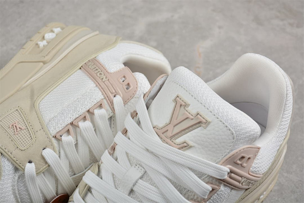 Close-up of the sneaker tongues, laces, and pale pink logo details.