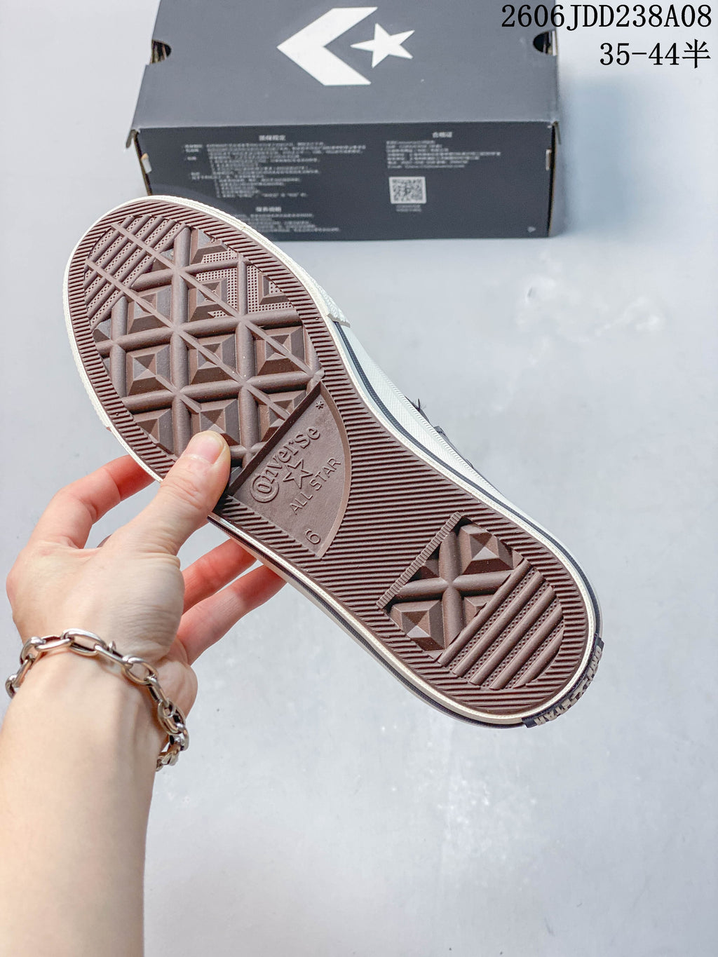 Close-up of the sneaker outsole showing its patterned tread and embossed Converse All Star marking.