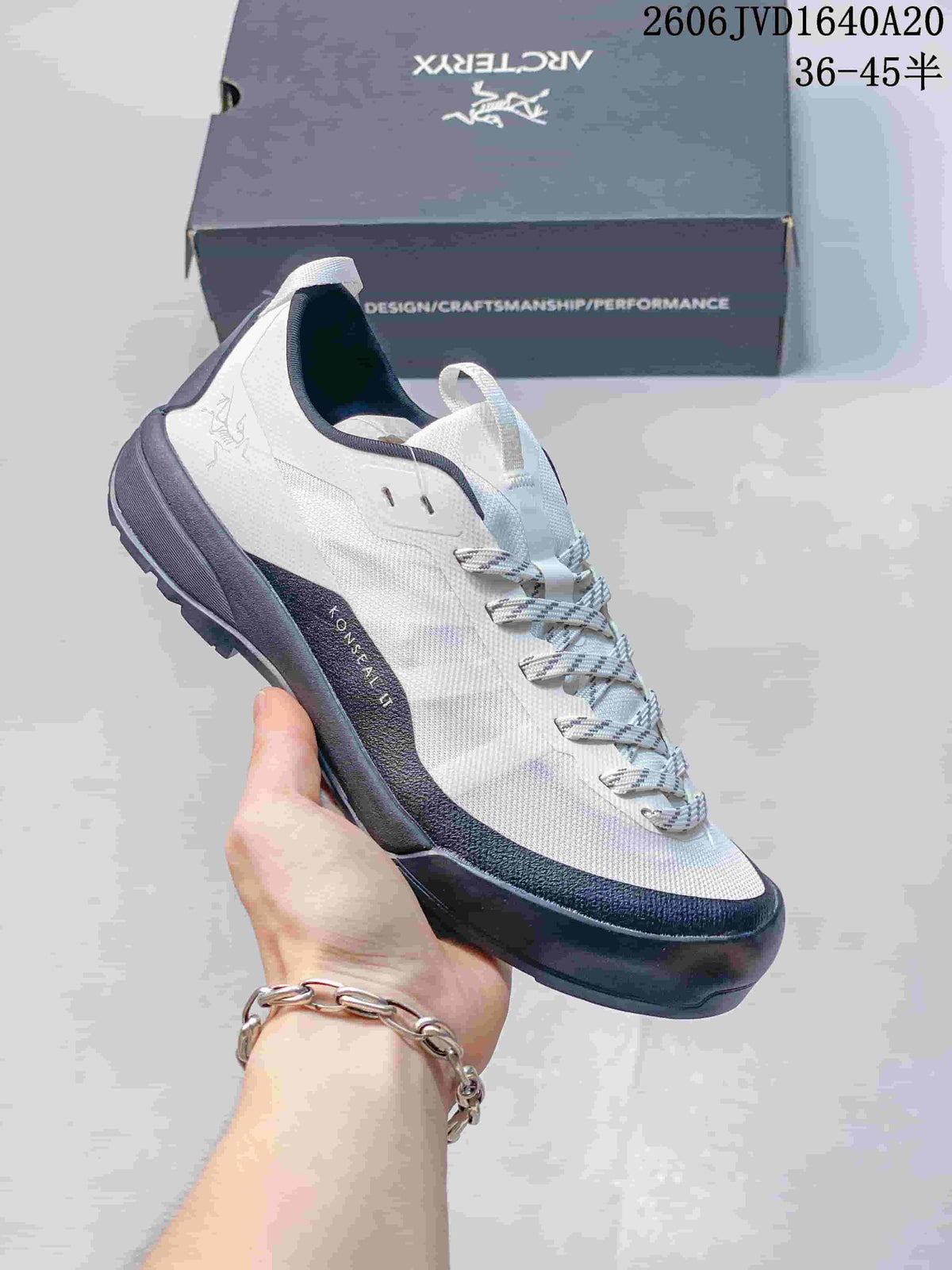 White and dark gray Arc'teryx Konseal LT shoe shown beside a branded box; image overlay lists sizes 36–45.5.