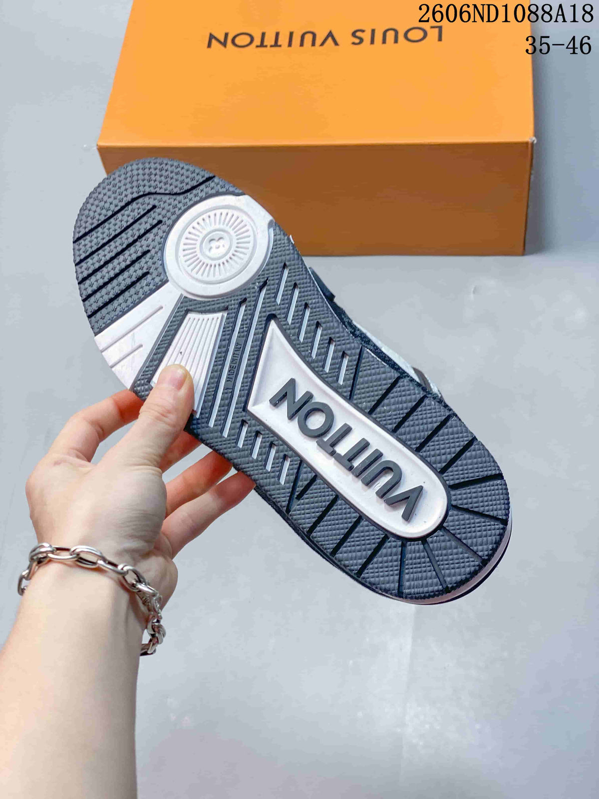 Underside view showing the patterned tread and contrasting outsole of a Louis Vuitton Trainer sneaker.
