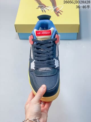 Front view of a navy-blue and yellow Air Jordan 4 sneaker with red and white lace supports
