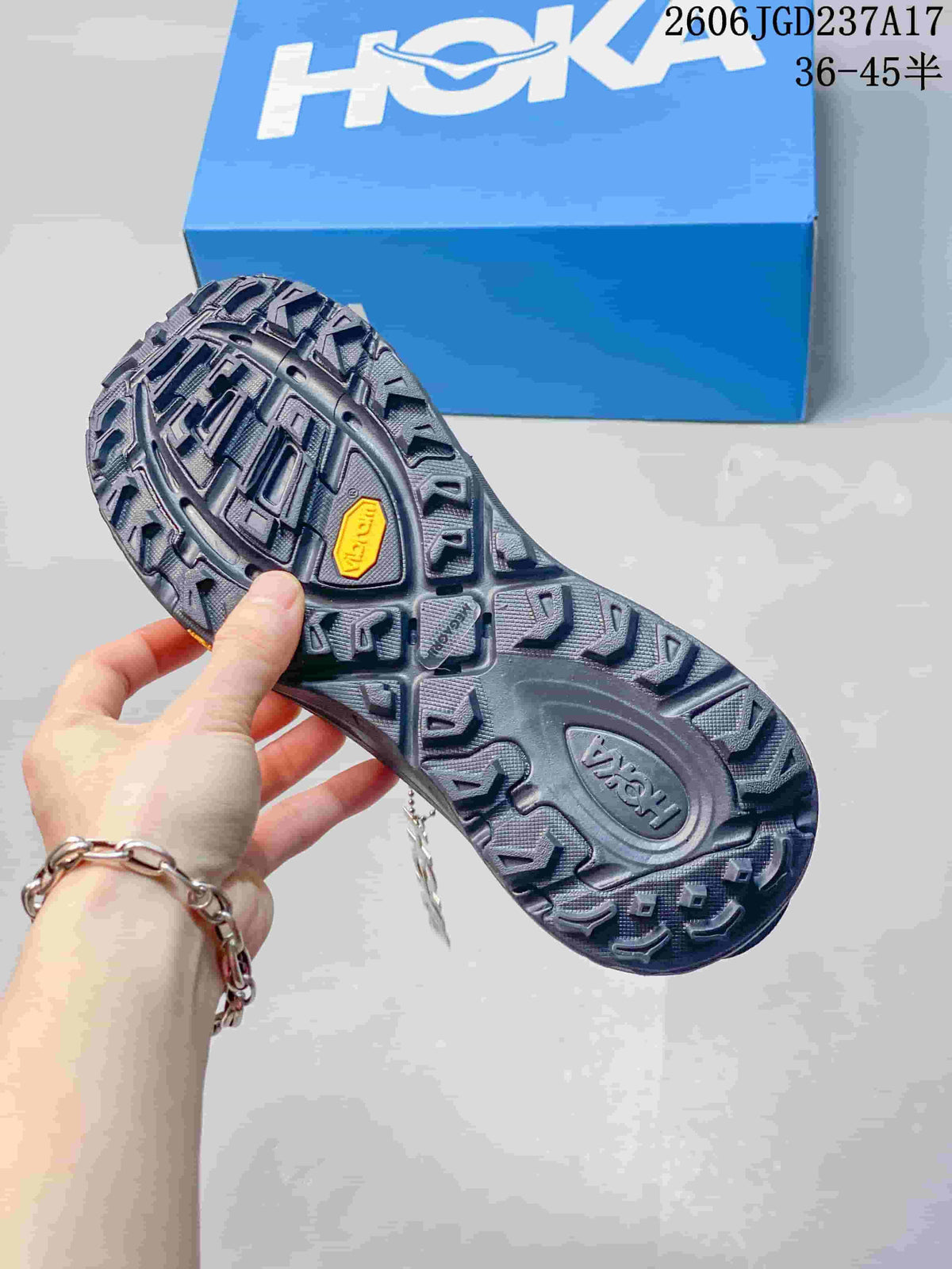 Close-up of the deeply treaded outsole on a HOKA trail shoe